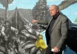John Riddell points out the gum diggers on the mural at the launch of Paint NZ Beautiful